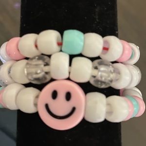 Bracelet set of three, white and pink themed.